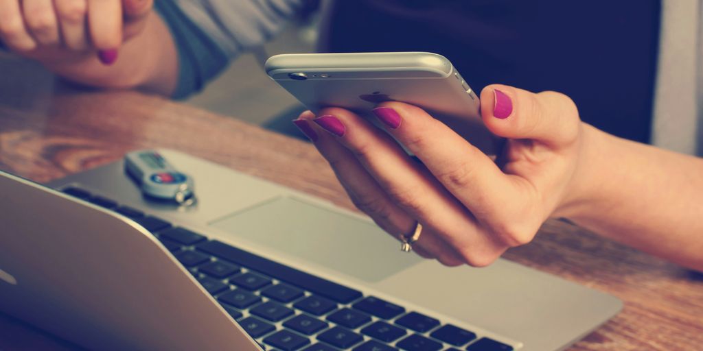 woman holding silver iPhone 6